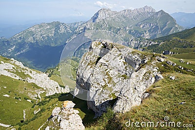 Picteresque view of a huge rock, green hillside, mountain in North Osetia Russia Stock Photo